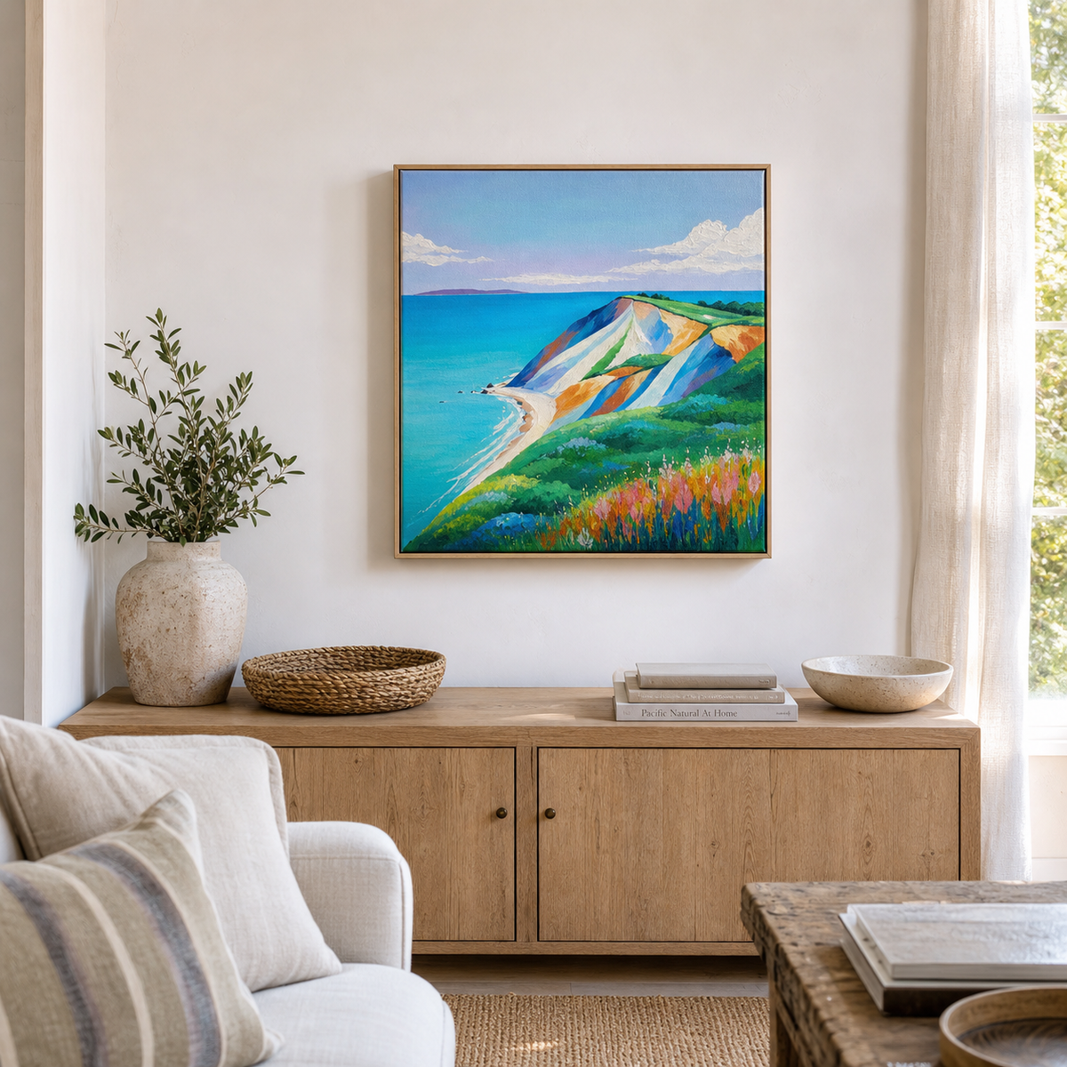 Aquinnah by Amber Miro, original painting of clay cliffs above ocean blue, in a wood floater frame above a sideboard