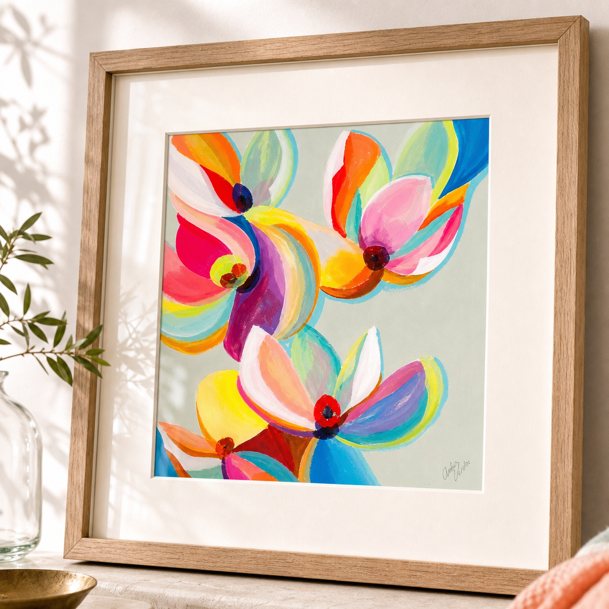 Magnolia Colors by Amber Miro, original magnolia painting in orange and magenta, angled view, matted in an oak frame
