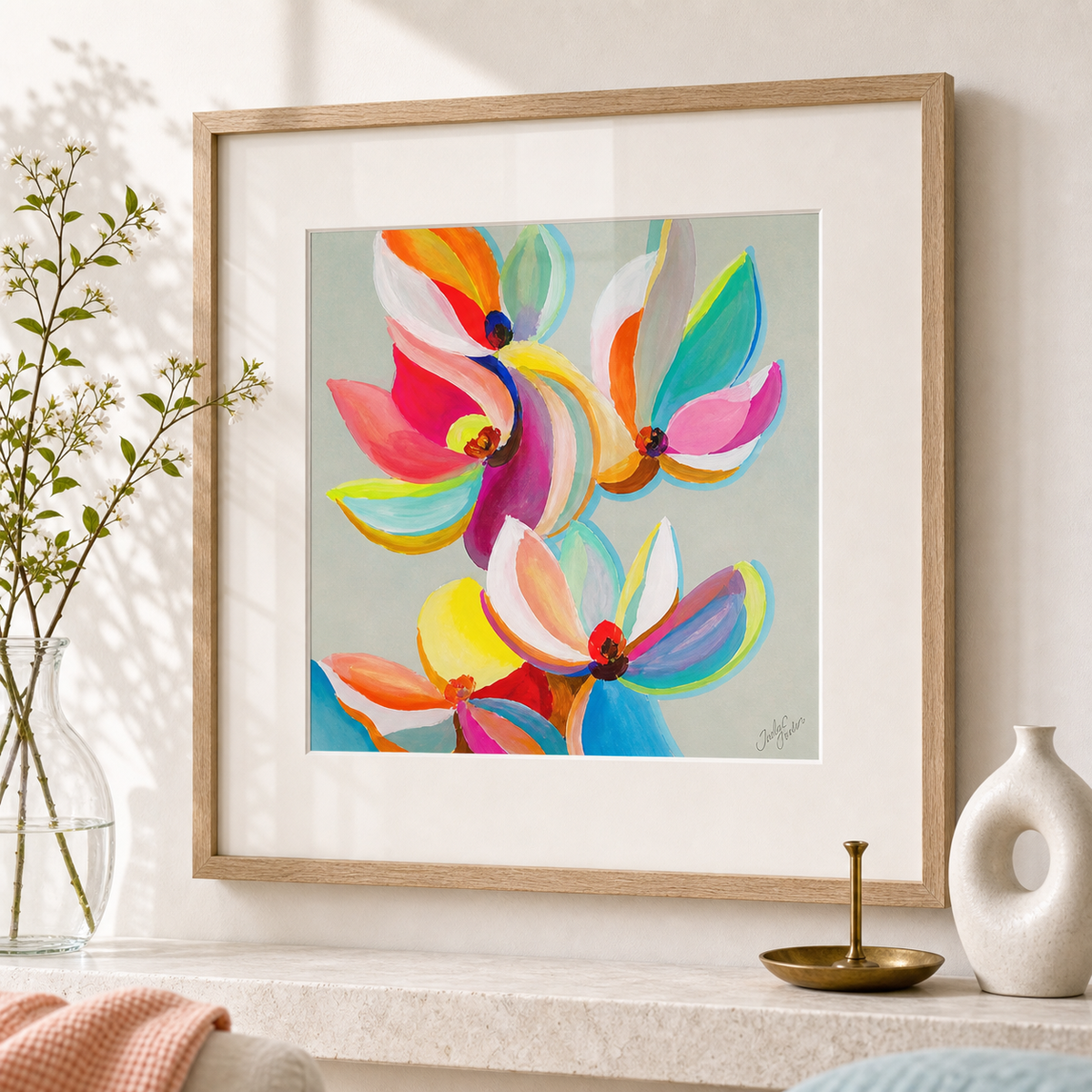 Magnolia Colors by Amber Miro, original magnolia painting in orange and magenta, leaning on a stone shelf beside a vase