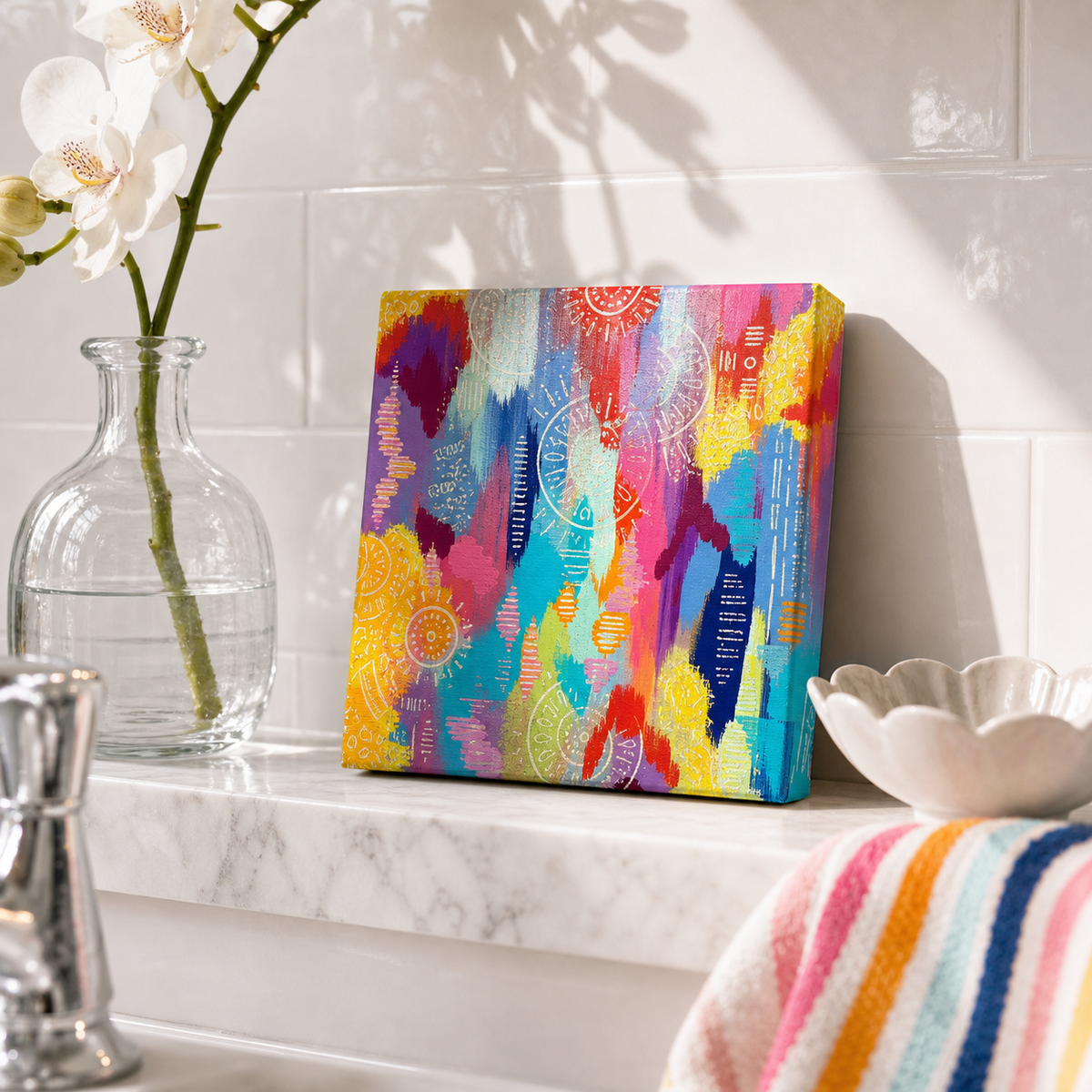 Pink Study by Amber Miro, original small abstract in hot pink, teal, and yellow, leaning on a marble shelf beside an orchid