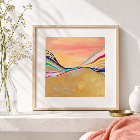 Pink Electric by Amber Miro, original sunset painting in coral, gold, and hot pink, matted in a wood frame on a stone shelf