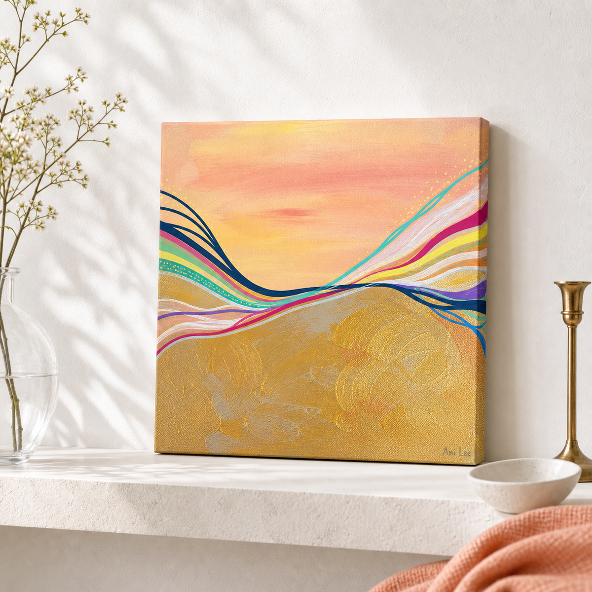 Pink Electric by Amber Miro, original sunset painting in coral, gold, and hot pink, unframed canvas leaning on a white shelf