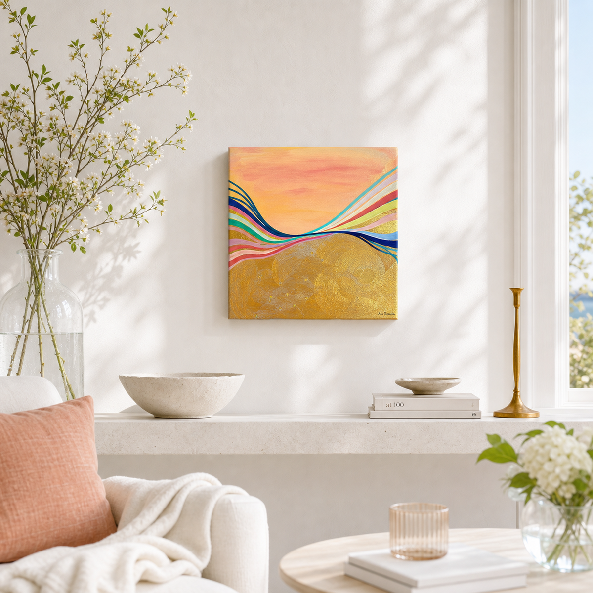 Pink Electric by Amber Miro, original sunset painting in coral, gold, and hot pink, hanging unframed above a shelf